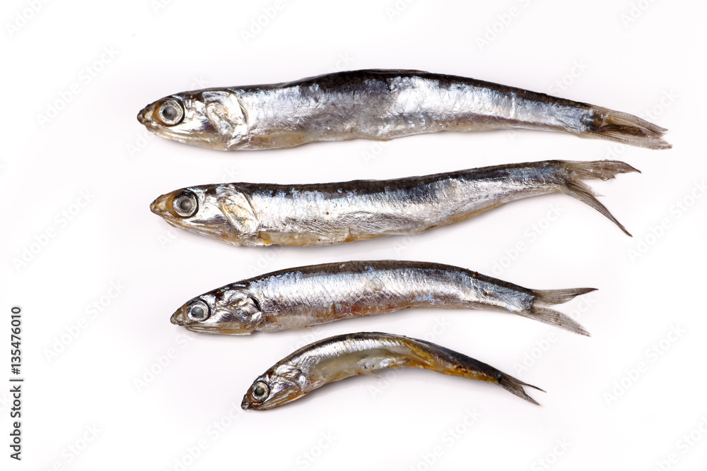 Anchovy from the Black sea - salted small fish lying on a white Anchovy from the Black sea - salted small fish lying on a white