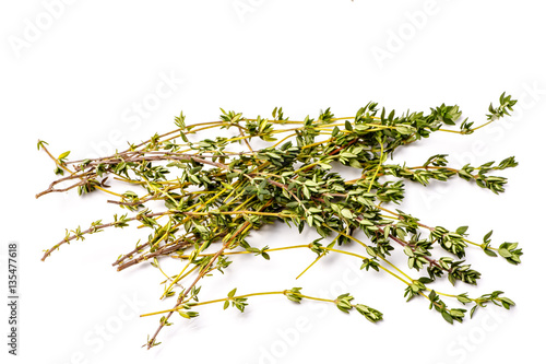 Fresh thyme sprigs lie on a white background, not isolated.