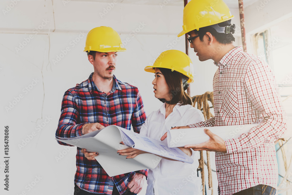 three construction engineers working together in side building p three construction engineers working together in side building p