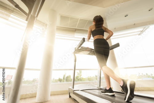 Teenage girl exercise on running machine
