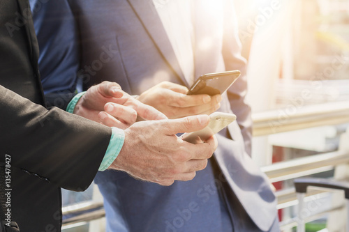 Two Westerner business man using smartphone