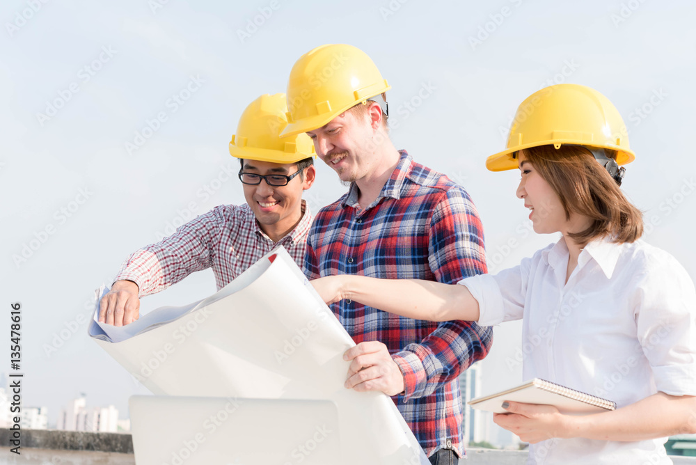 three construction engineers working outdoors in construction si three construction engineers working outdoors in construction si