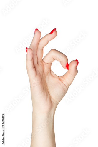Woman hand in ok sign with manicure and red nails on a white isolated