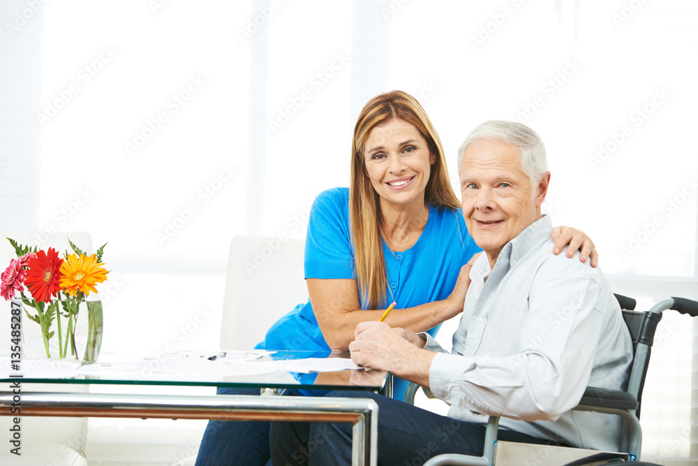 Obraz premium Woman and senior man filling out forms
