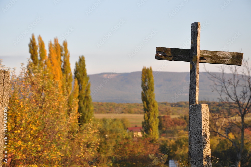 Autumn evening country view with wooden cross