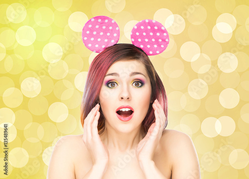 Εκτύπωση καμβά Beautiful young smiling woman in mickey mouse ears on bubble background