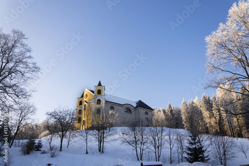 Church of Assumption in snowy mountains country, Neratov, Orlicke hory photo