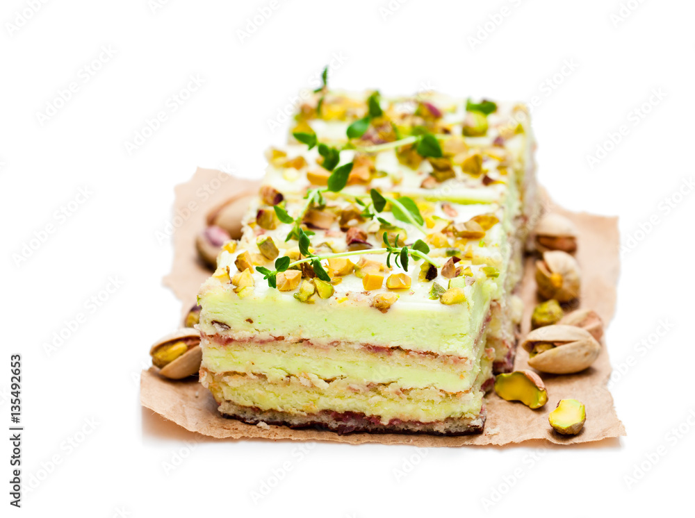 Slices of layered cake with pistachio isolated on white Slices of layered cake with pistachio isolated on white