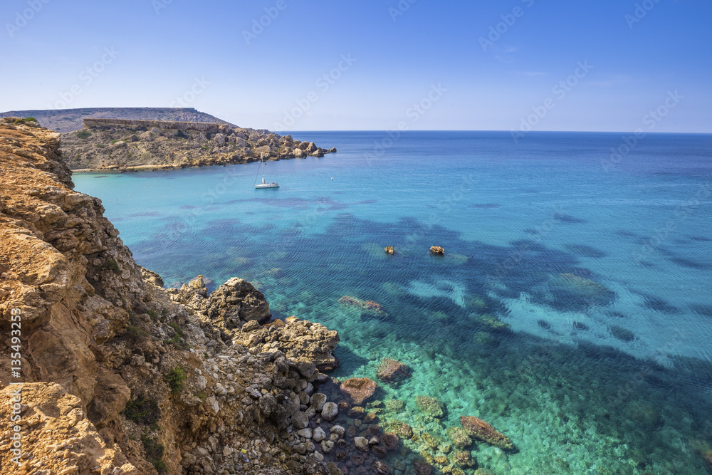 Malta - Ghajn Tuffieha bay view on a nice summer day with crystal clear sea water and blue sky
