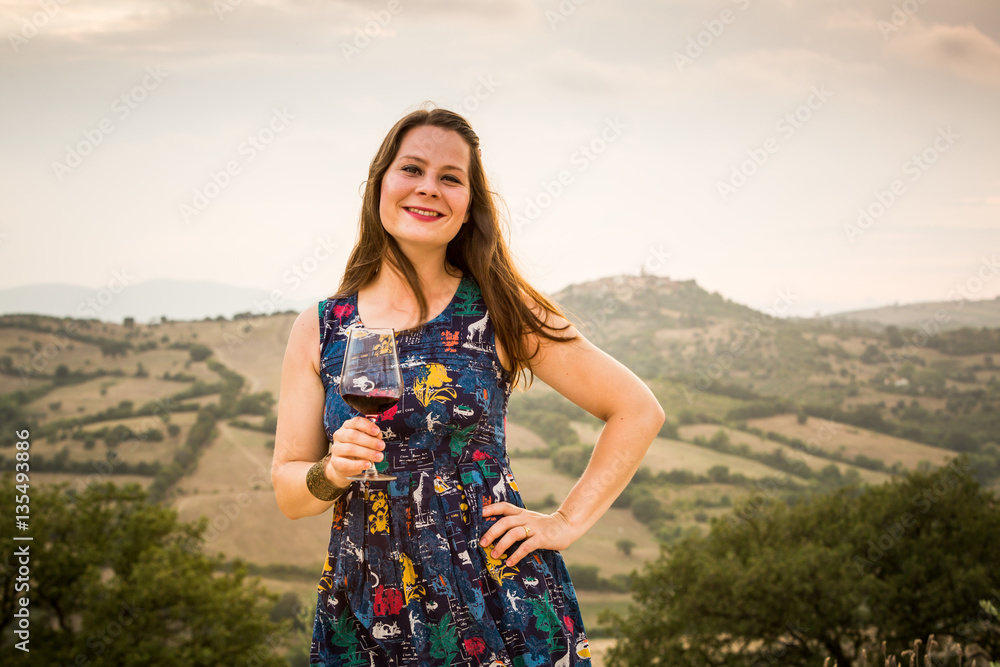 Girl in blue dress with a glass of wine in Tuscany, Italy Girl in blue dress with a glass of wine in Tuscany, Italy