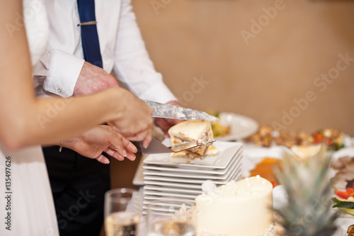 Man with a knife cut the cake into pieces 7415.