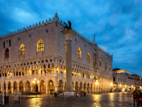 Facade of The Doge's Palace in Venice, lit up by the light of the lampposts in the early morning.