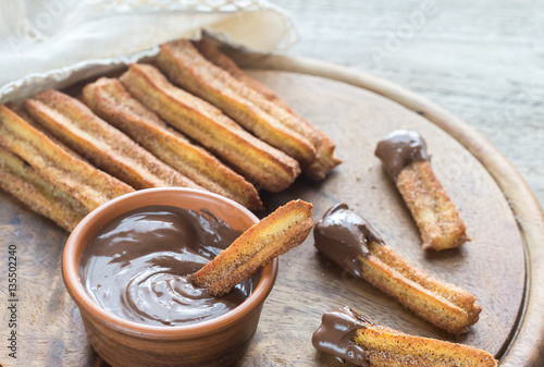 Churros - famous Spanish dessert with chocolate sauce