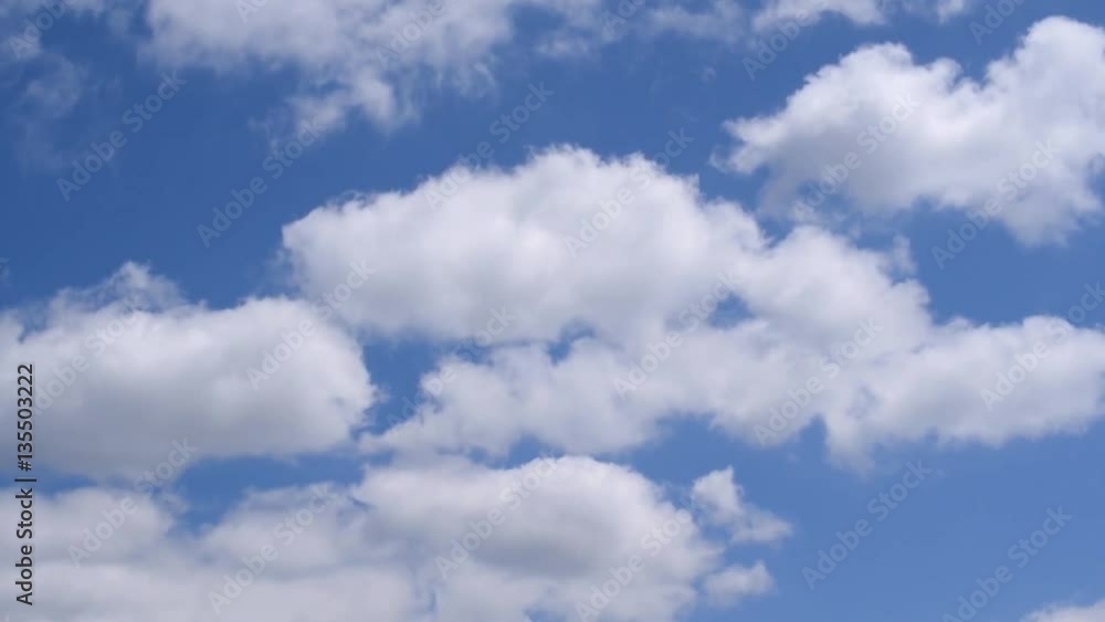 Beautiful white cumulus clouds moving on background of blue sky Beautiful white cumulus clouds moving on background of blue sky