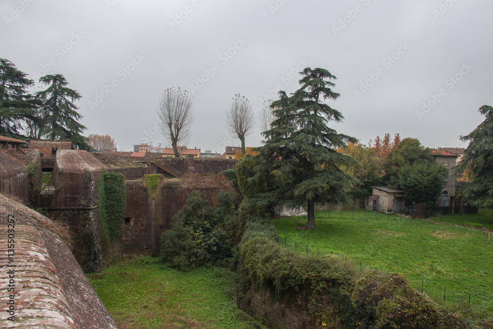 Brick walls and moat around Medici Fortress of Santa Barbara. Pistoia. Tuscany. Italy.