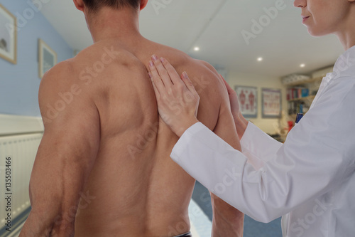 Man having chiropractic back adjustment . Osteopathy, Alternative medicine, pain relief concept. Physiotherapy, sport injury rehabilitation