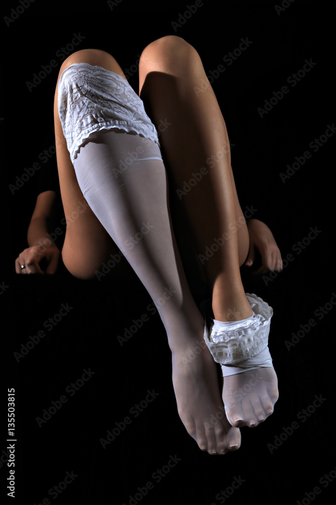 Sexy woman put on her white nylon stockings on long fit legs Stock Photo |  Adobe Stock