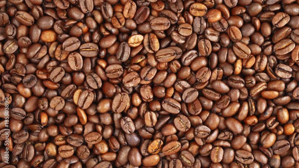 The texture of the roasted coffee beans on a swivel background The texture of the roasted coffee beans on a swivel background