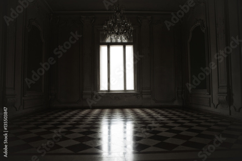 Window lit with mysterious white light in a spooky room built in