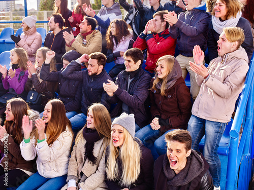 Fans cheering in stadium people applaud your favorite team and singing on tribunes. Group youth group support your favorite team.