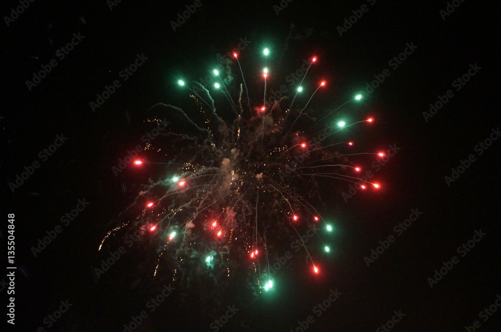 Red and Green Fireworks Burst into the Air