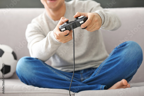 Teenager playing videogame ...