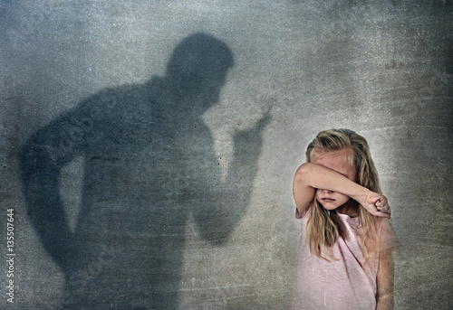 father or teacher shadow screaming angry reproving young sweet little schoolgirl or daughter photo
