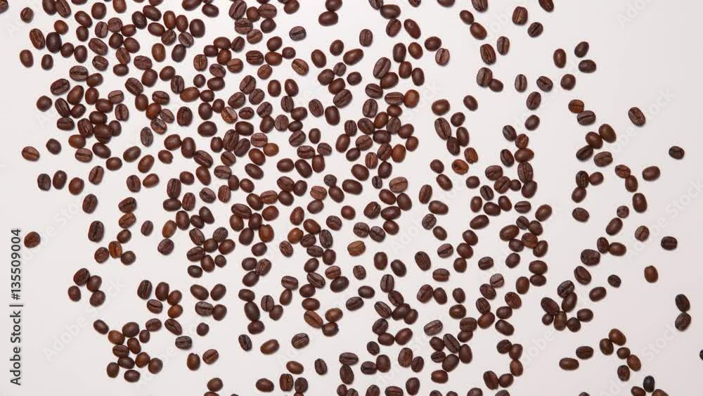 Texture of coffee beans scattered on a white background Texture of coffee beans scattered on a white background