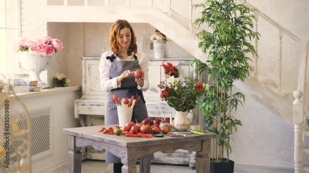 Chef woman and florist preparing fruits and vegetables for making fruit bouquet and talks smiling Chef woman and florist preparing fruits and vegetables for making fruit bouquet and talks smiling