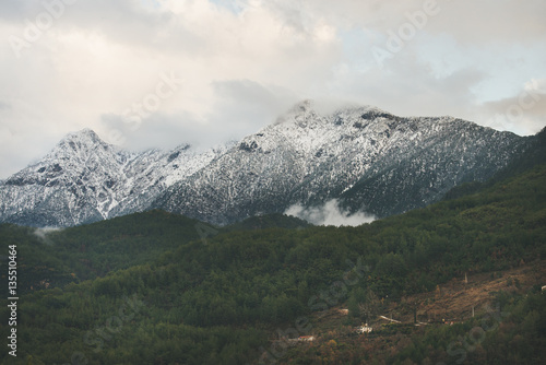 Green slopes of the Taurus mountains covered with snow in winter. Southern Turkey, Alanya, Dim Cay river valley