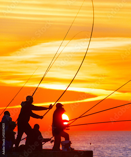 Fishers at beautiful sunset