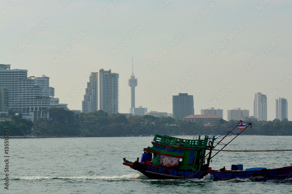 Old thai boat is coming back from fishing