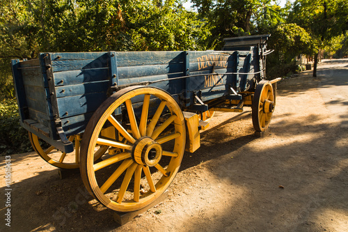 Late afternoon over a gold rush era horse drawn wooden freight wagon in Columbia, California