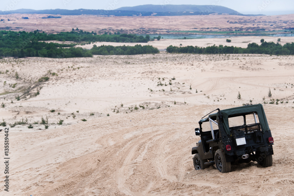 Jeep car with white sands. Vietnam desert,Popular tourist attrac Jeep car with white sands. Vietnam desert,Popular tourist attrac
