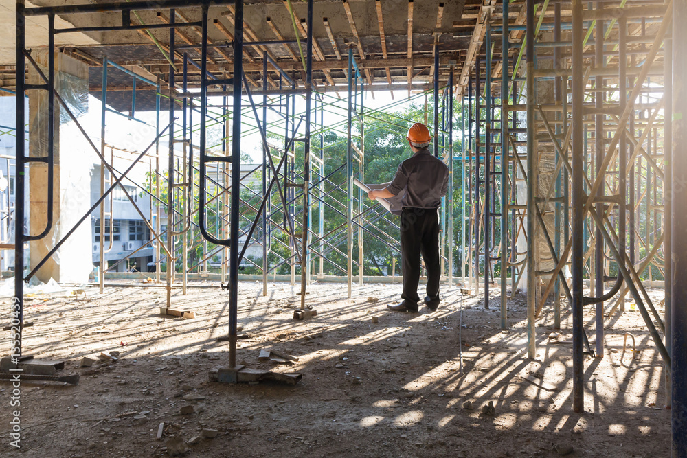 Construction concepts, Engineer and Architect working at Construction Site with blueprint Construction concepts, Engineer and Architect working at Construction Site with blueprint