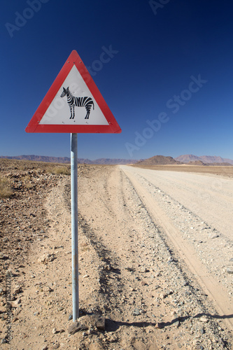 Zebra caution sign on the road