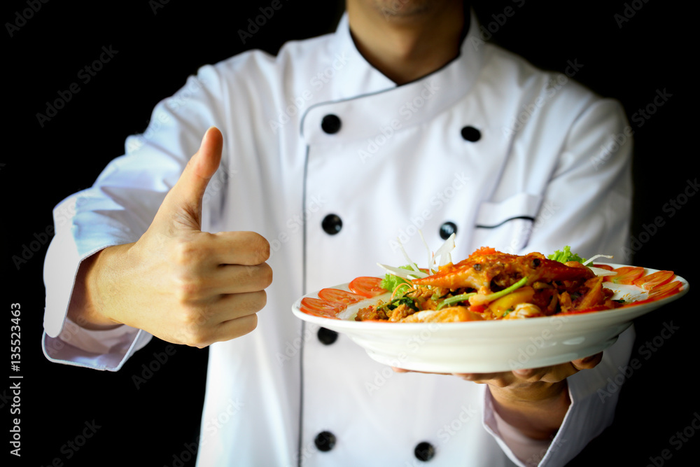 Chef proudly presenting Curry Crab with Coconut and showing thumbs up Chef proudly presenting Curry Crab with Coconut and showing thumbs up
