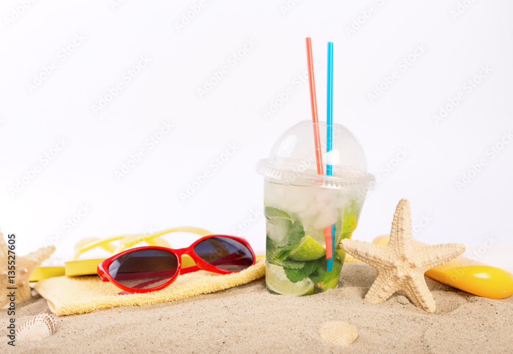 Refreshing cocktail with beach items close up