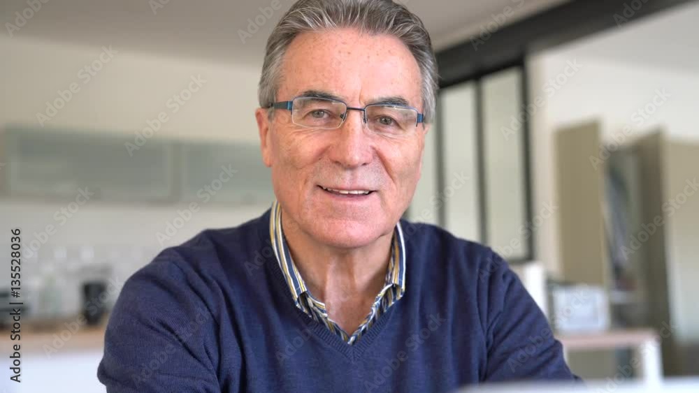 Senior man with eyeglasses using laptop computer Senior man with eyeglasses using laptop computer