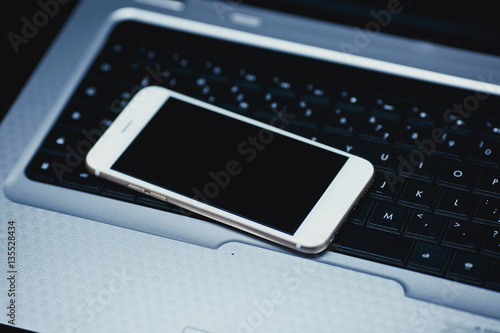 Smartphone laying on black background. Mouse and keyboard isolated.  photo