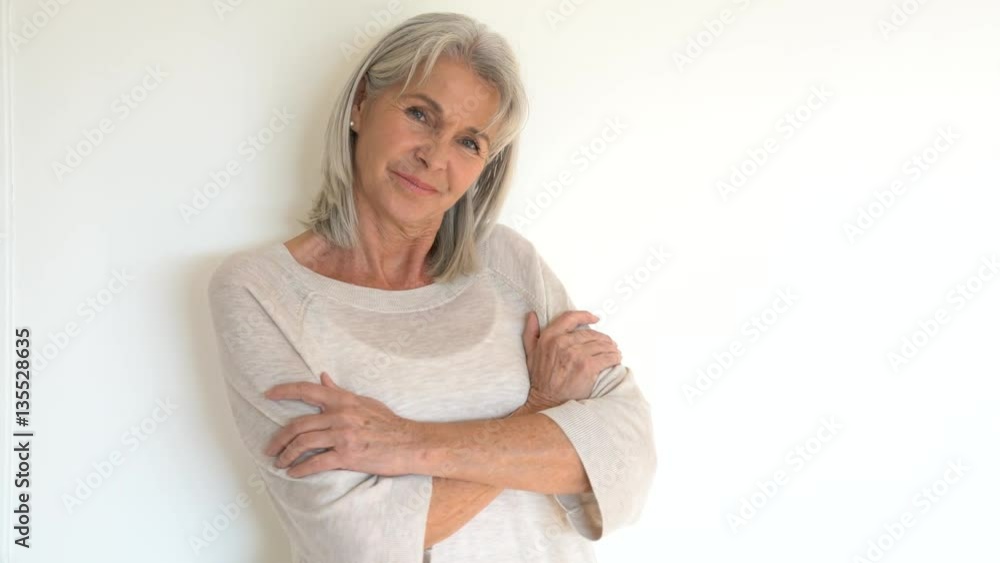 Senior woman standing on white background Senior woman standing on white background