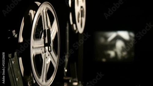 A retro movie projector with moving reels. 