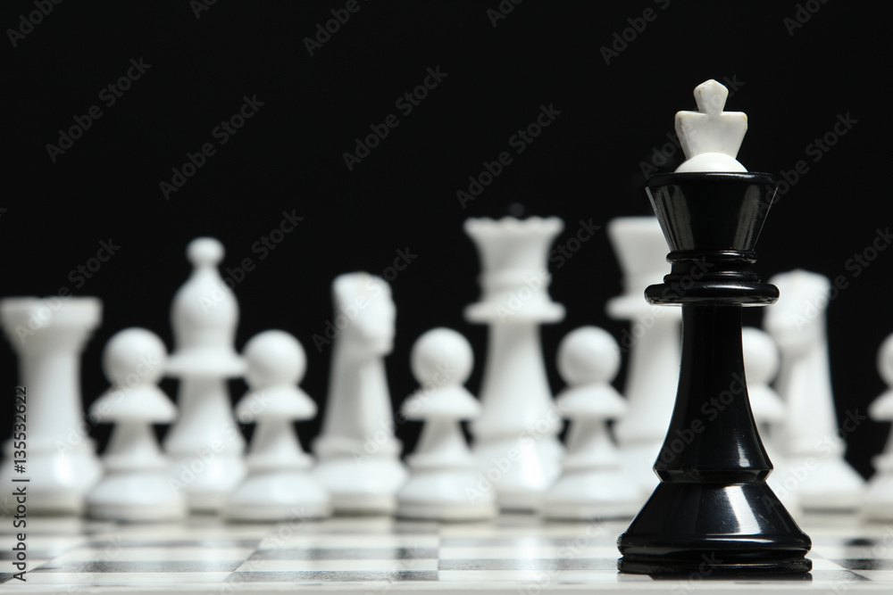 Chess pieces on the board on a dark background. Chess pieces on the board on a dark background.