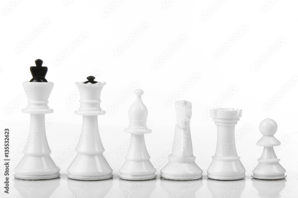 Chess pieces lined up in a row on a white background isolated. Chess pieces lined up in a row on a white background isolated.
