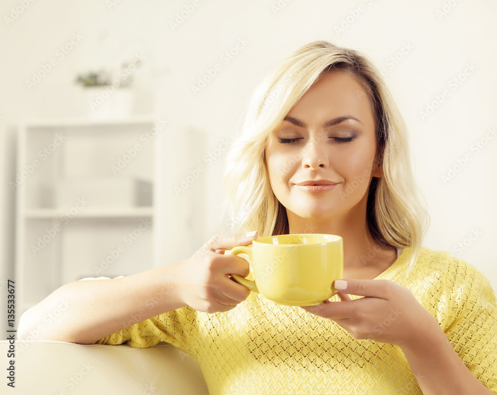 Attractive happy girl with a cup of coffee at home. Attractive happy girl with a cup of coffee at home.