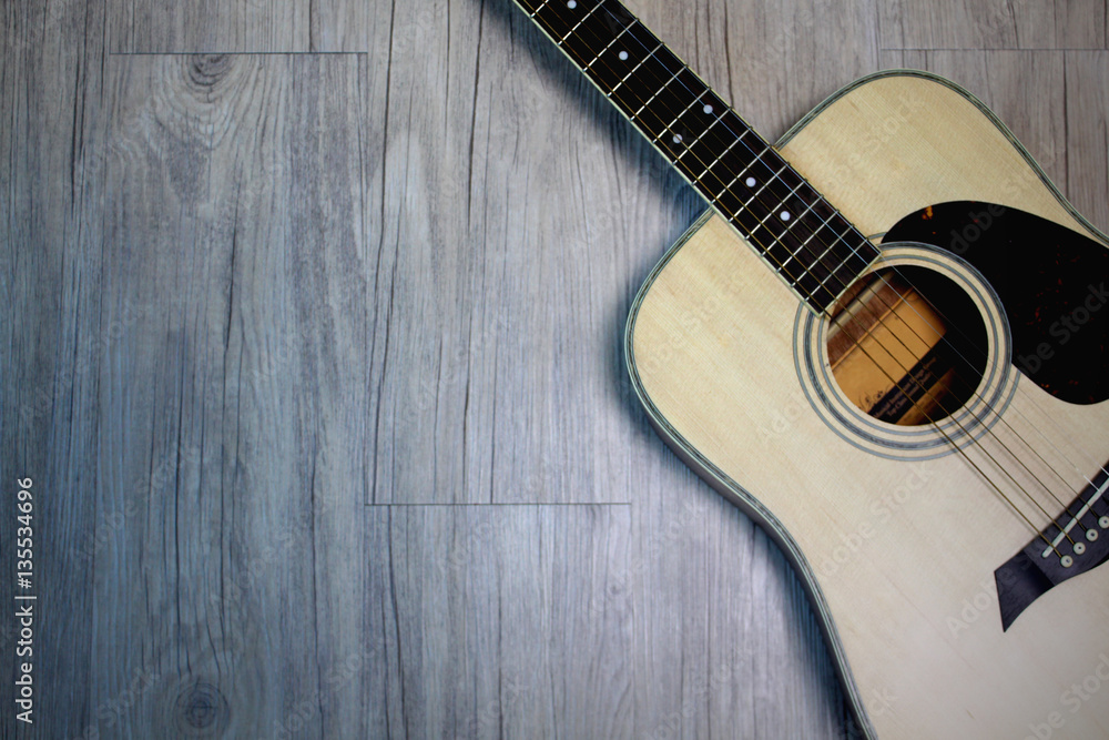 Fototapeta premium Acoustic guitar on wooden background