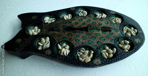Batik Mancala from Java, Indonesia. Mancala is a family of board games played around the world. Also known as Dakon or Congklak in South East Asia. photo