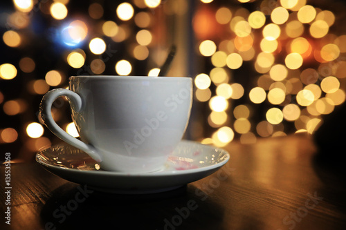 cup of coffee on the table on blured background with circle boke