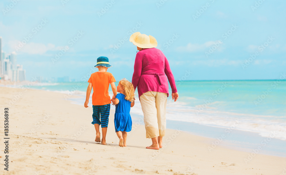 grandmother with kids- little boy and girl- at beach