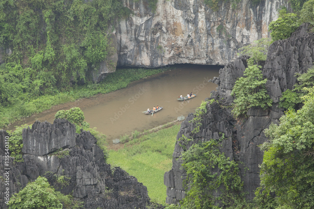 Boats carrying tourist on Ngo Dong river in Tam Coc Bich Dong in Ninh Binh, Vietnam. 